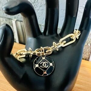 Elegant Gold Bracelet with Black Pendant